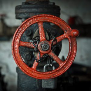 A red fire hydrant with the handle of it.