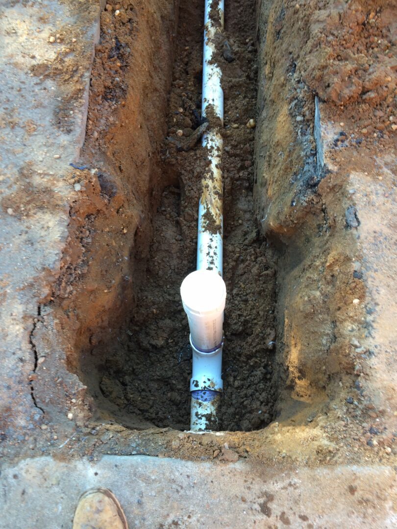 A pipe that is in the ground with dirt.