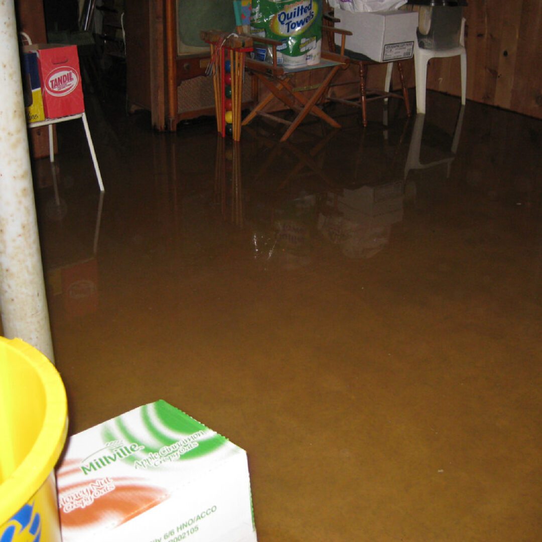 A flooded room with a table and chairs in the middle.