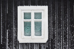 A window with snow on the outside of it.