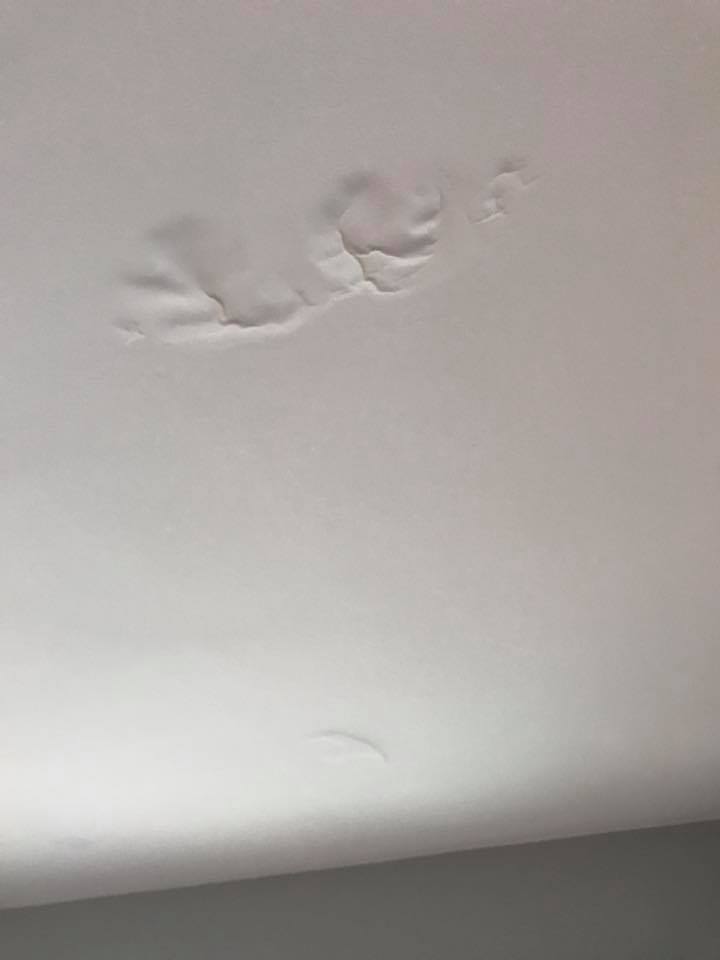 A white ceiling with some footprints on it